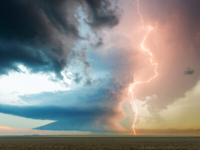 A spectacular supercell storm cloud with a lightning bolt, showcasing nature's awe-inspiring power and atmospheric beauty in a single frame.